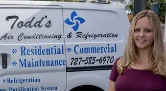 A woman stands beside a white van marked “Todd’s Air Conditioning & Refrigeration” with residential, commercial, and maintenance services listed.